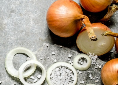 Vidalia Onions whole and rings on a grey slate with salt close up. Cultured Onion Juice Powder Awareness Photo